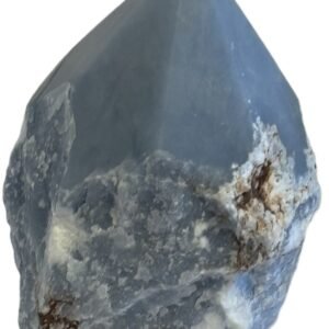 Natural rough angelite freeform with polished point 4 sians emporium Natural rough angelite freeform crystal with unpolished sides and a smooth polished blue point standing on a white background